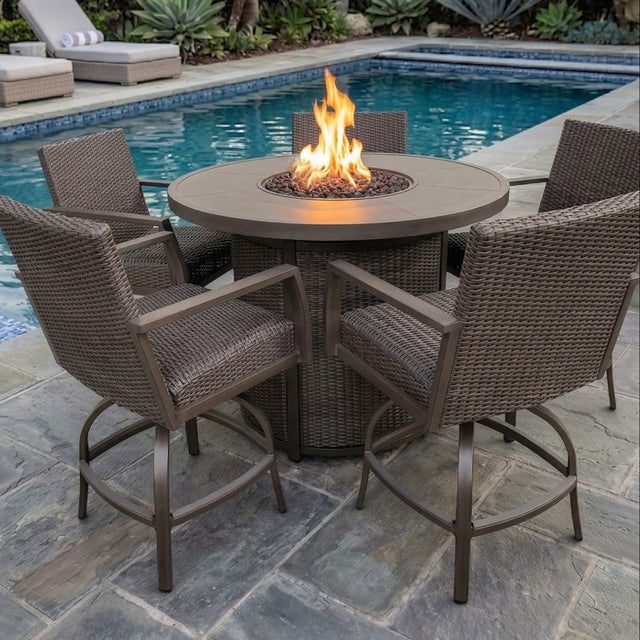 This is a lifestyle image showing these five wicker barstools around a wicker fire pit table on a stone patio next to an inground pool.