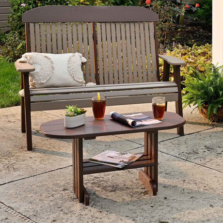 This is a lifestyle image showing the Chestnut Brown colored coffee table in front of a Weatherwood and Chestnut Brown colored bench.