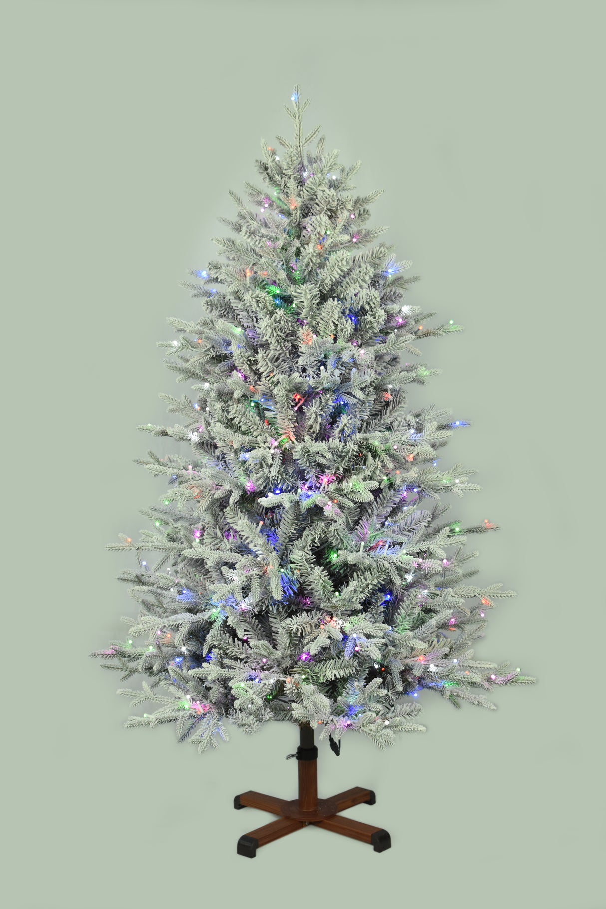 This image shows the flocked Christmas tree pre-lit with Multi-Colored Starry Lights. The tree is up against a light gray background.