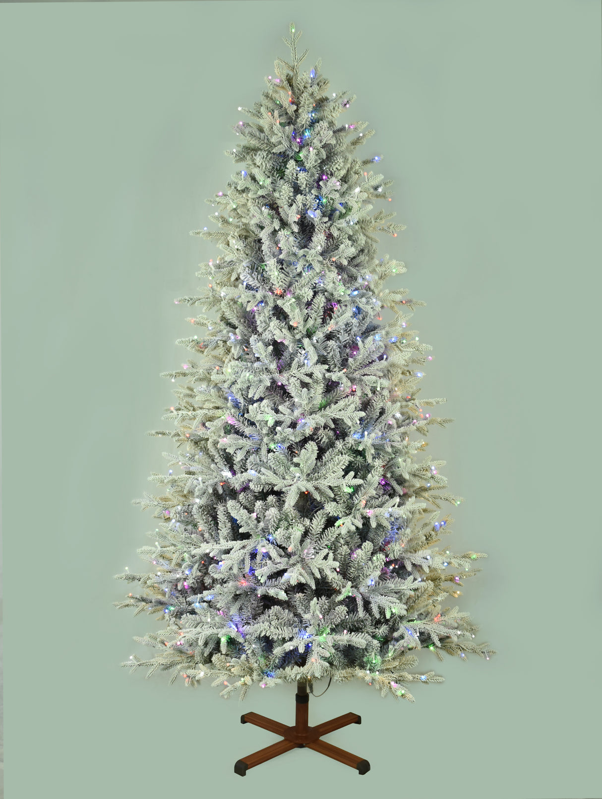 This image shows the flocked Christmas tree pre-lit with Multi-Colored Starry Lights. The tree is up against a light gray background.