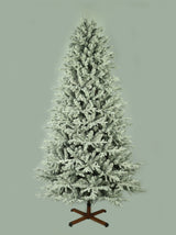 This image shows the flocked Christmas tree with the lights turned off. The tree is up against a light gray background.