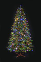This image shows the tree with Multi-Colored Starry Lights. It has a wooden stand. This tree is shown against a black background.