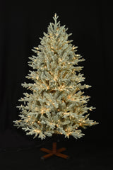 This image shows the flocked Christmas tree pre-lit with Warm White Starry Lights. The tree is up against a black background.