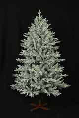 This image shows the flocked Christmas tree with the lights turned off. The tree is up against a black background.