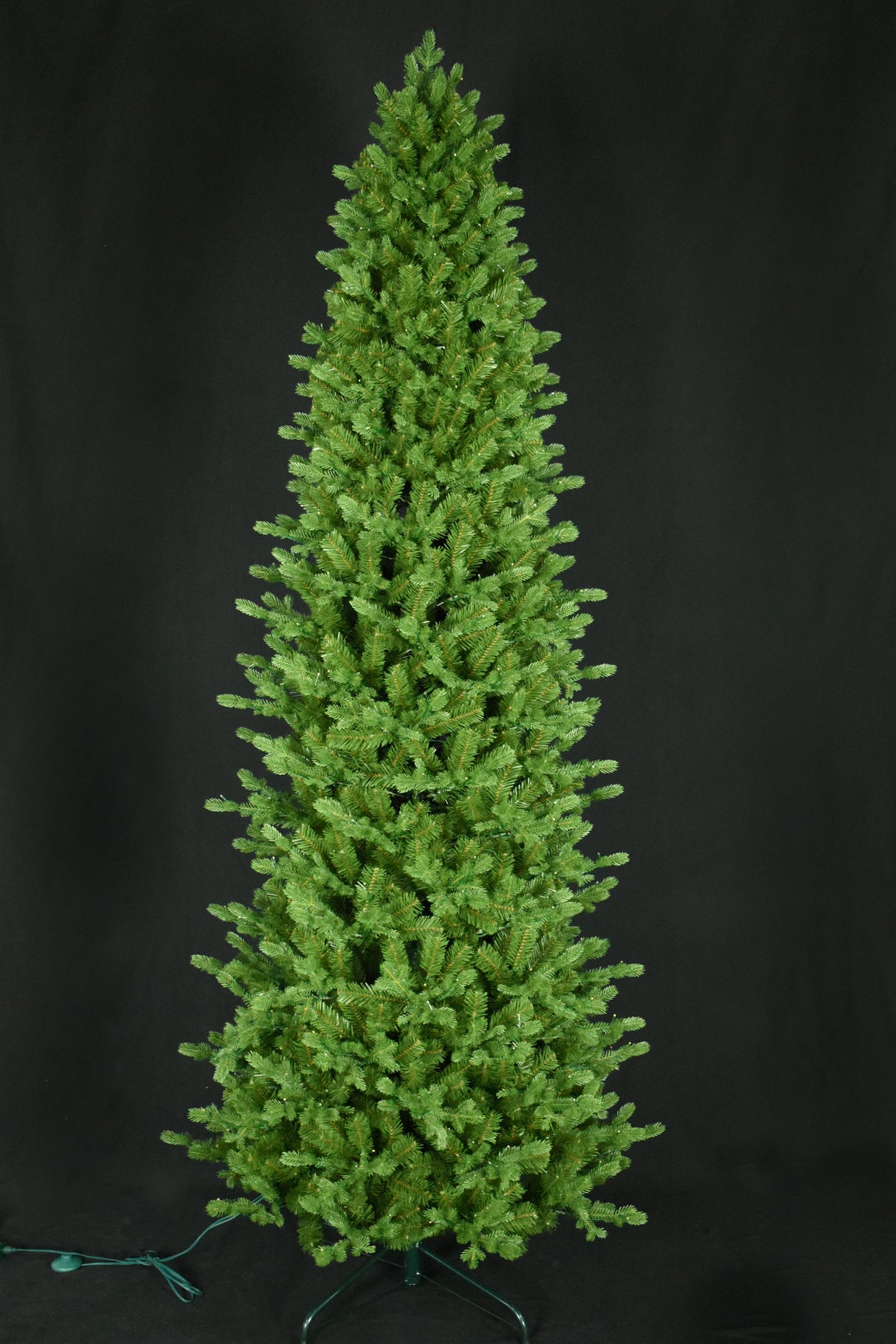 This image shows this specific artificial tree with the lights turned off. This tree is up against a black background.