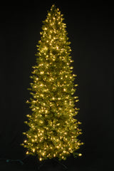 This image shows this specific artificial tree pre-lit with Warm White Starry Lights. This tree is up against a black background.