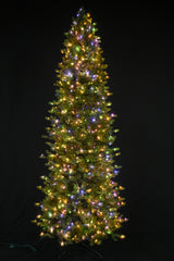 This image shows this specific artificial tree pre-lit with Multi-Colored Starry Lights. This tree is up against a black background.