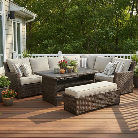 This is a lifestyle image showing this cushioned patio furniture set on a wooden porch next to a house in a grassy backyard.
