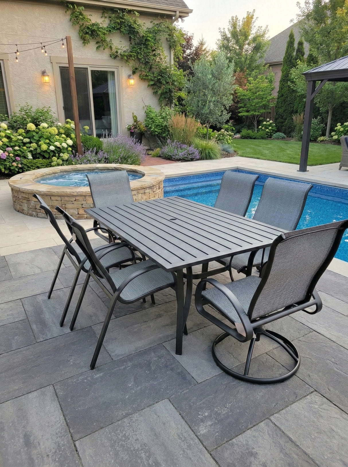This is a lifestyle image showing this patio dining set on a stone patio next to an in-ground pool.