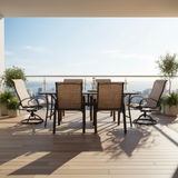 This is a lifestyle image showing this patio dining set with sling backs on a wooden balcony overlooking a city skyline on a sunny day.