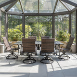 This is a lifestyle image showing this outdoor dining set with woven sling backs in a solarium on a sunny day.