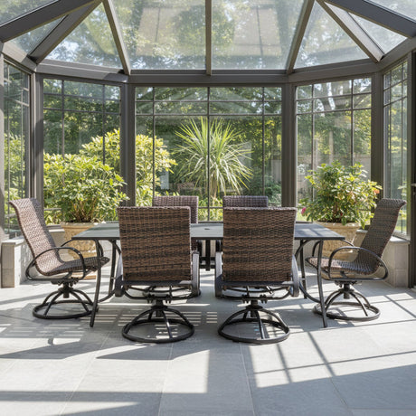 This is a lifestyle image showing this outdoor dining set with woven sling backs in a solarium on a sunny day.