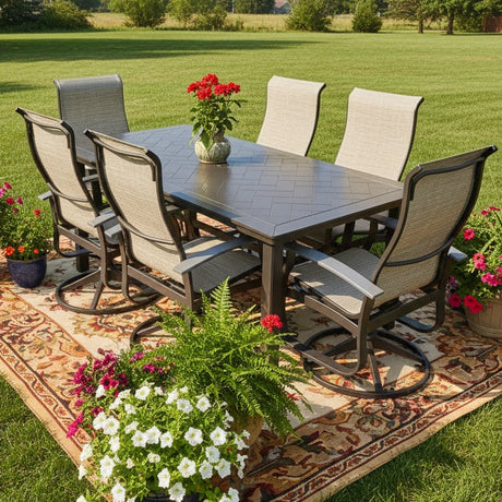 This is a lifestyle image showing this patio dining set on a colorful outdoor rug in a grassy backyard. There are potted plants all around.