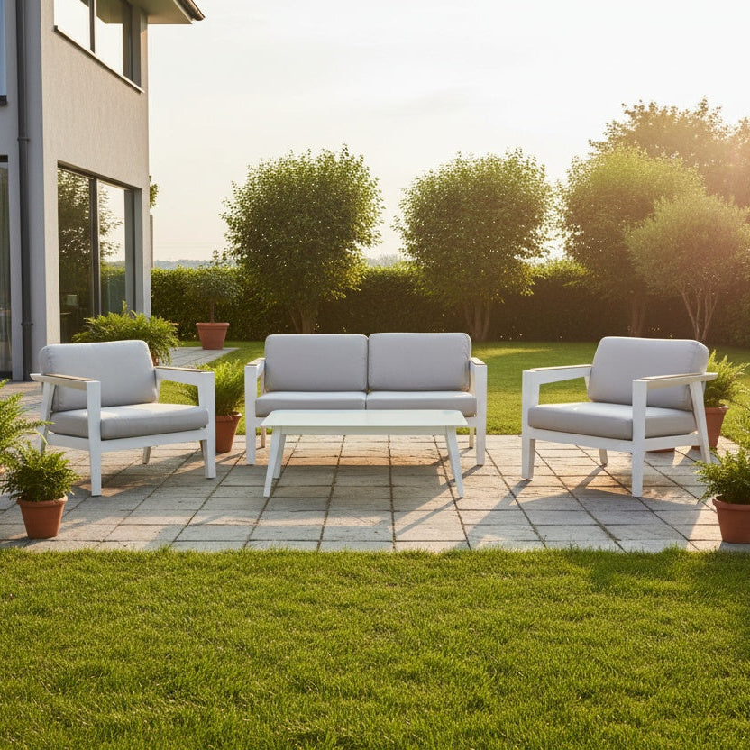 This is a lifestyle image showing the patio furniture set on a stone patio in a grassy backyard on a sunny day.
