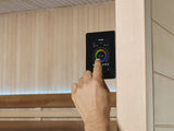 This image shows someone using the controls inside the sauna.