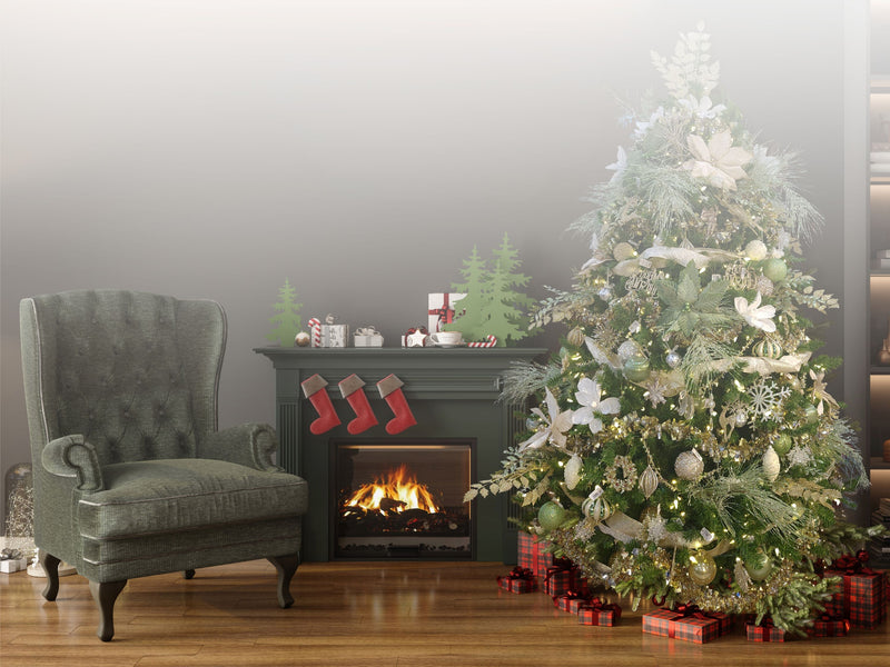 Cozy living room with a Christmas tree, fireplace, and armchair.