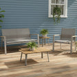 This is a lifestyle image showing this patio furniture set on a weathered wood back porch up against a blue house. There are small potted plants on the coffee table and the end table.