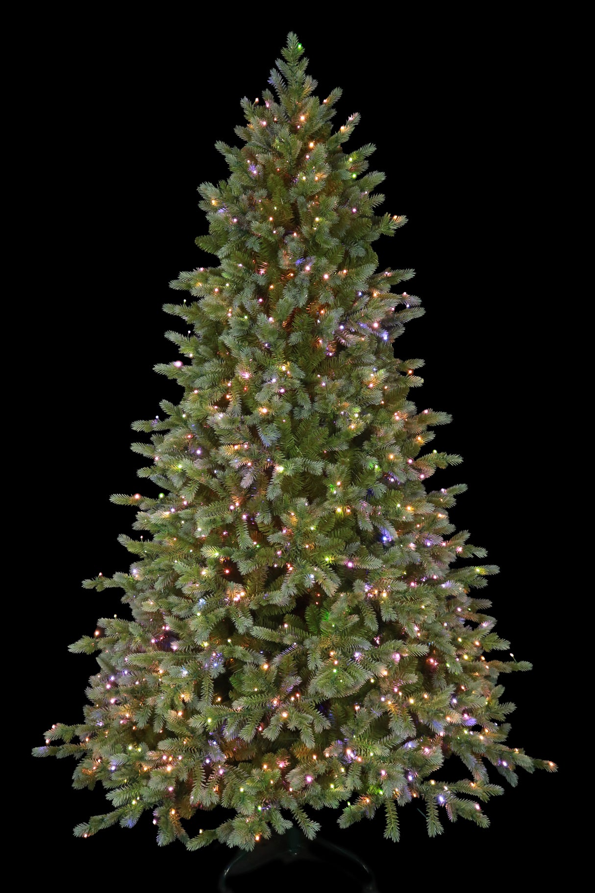 This is an image showing this artificial tree pre-lit with Multi-Colored Starry Lights. This tree is up against a black background.