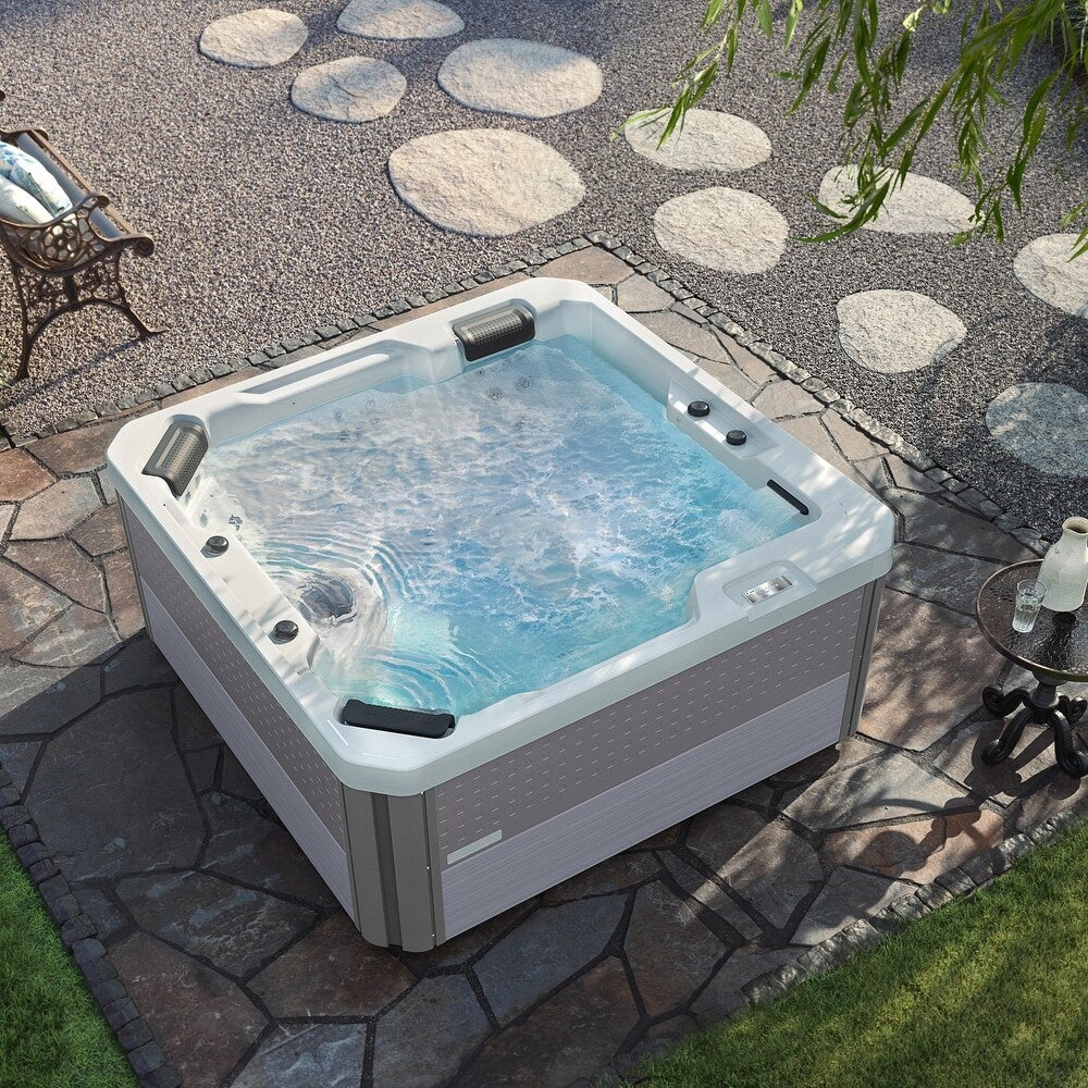 This is a lifestyle image showing the Inspire hot tub on a stone patio, taken from above.
