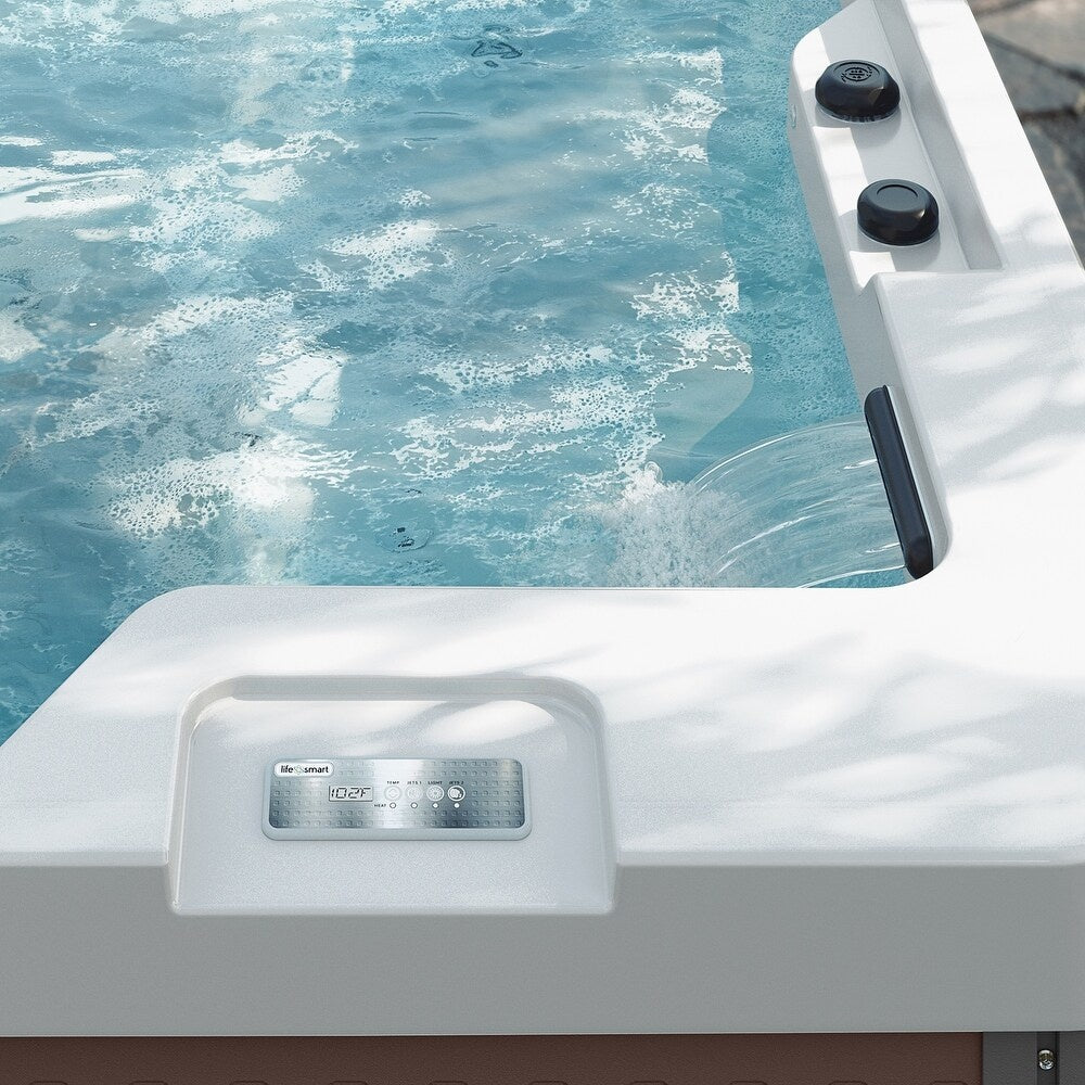 This is a lifestyle image showing the waterfall feature in the Inspire hot tub.