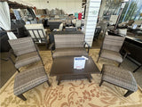 Clearance outdoor patio wicker chairs with textured patterned cushions on a yellow outdoor rug.