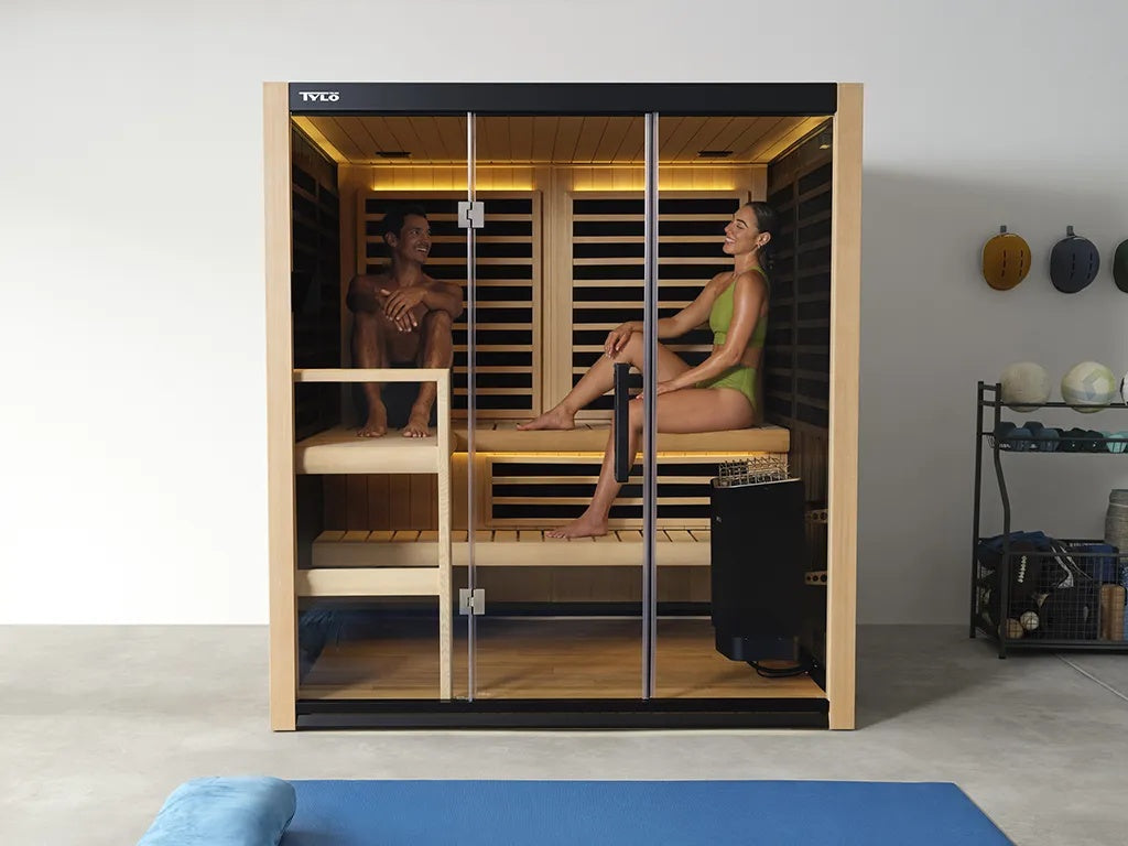 This is a lifestyle image showing two people sitting inside the sauna.