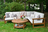 This is a lifestyle image showing an outdoor sofa with Antique Mahogany frames and Canvas colored cushions.