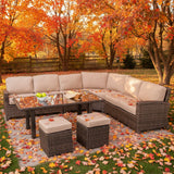 This is a lifestyle image showing this wicker cushioned sectional sofa, coffee table and two ottomans in a nice yard on a sunny, fall day.