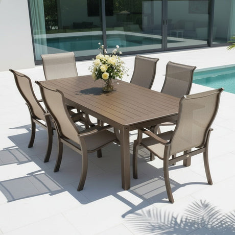 This is a lifestyle image showing this patio dining set on a concrete patio next to an in-ground pool.