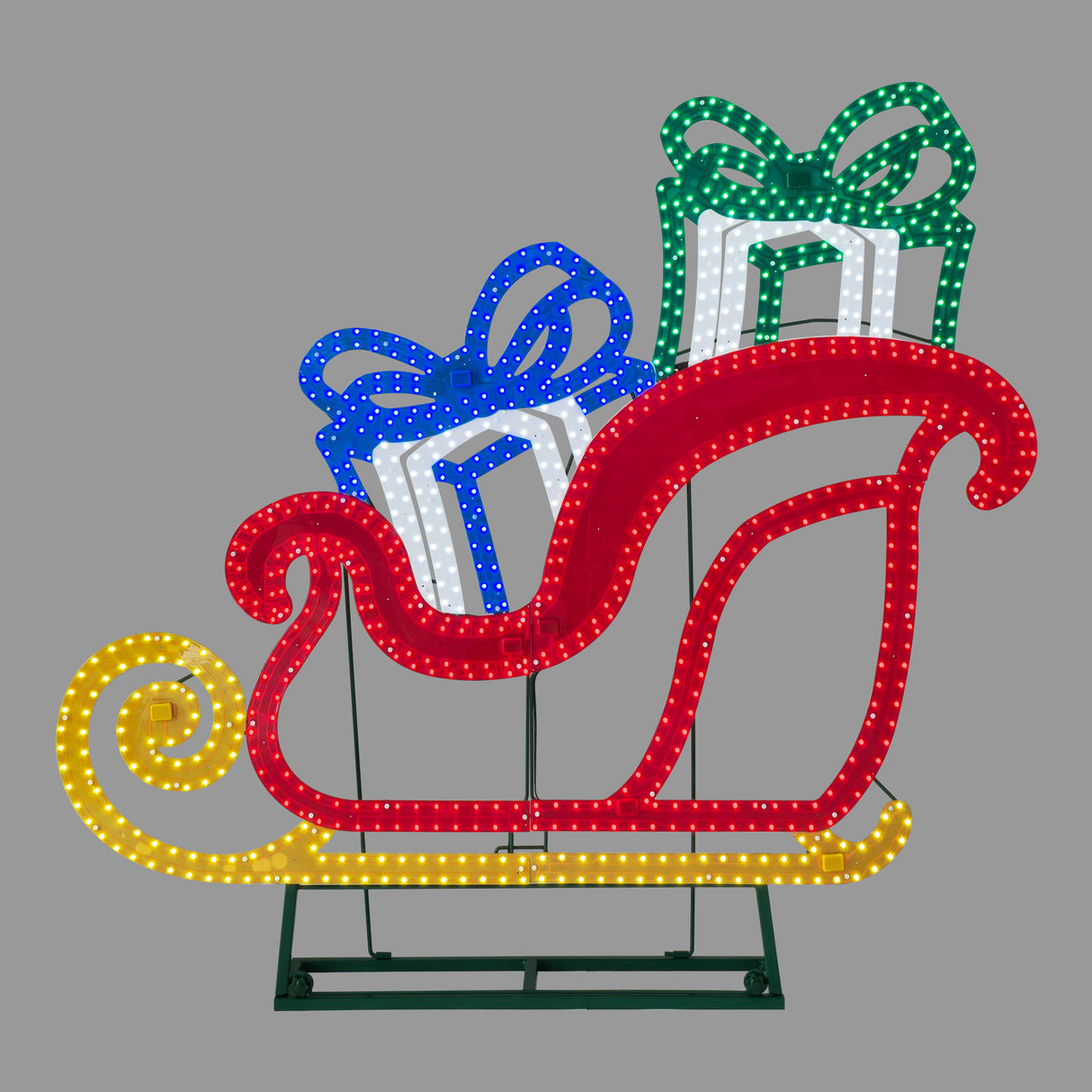 This image shows the LED sleigh on a gray background. The sleigh is red and the bottom part is yellow. There are two presents inside the sleigh: one is blue and white and the other is green and white.