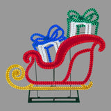 This image shows the LED sleigh on a gray background. The sleigh is red and the bottom part is yellow. There are two presents inside the sleigh: one is blue and white and the other is green and white.