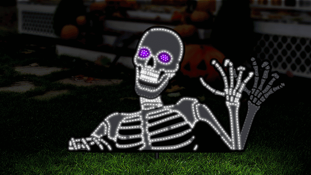 This is an animated image showing the skeleton decoration in motion. He appears to wave, his mouth opens and his eyes go from purple to black.