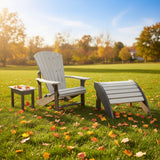 This is a lifestyle image showing this Adirondack chair, ottoman and side table in a grassy yard on a sunny, fall day.