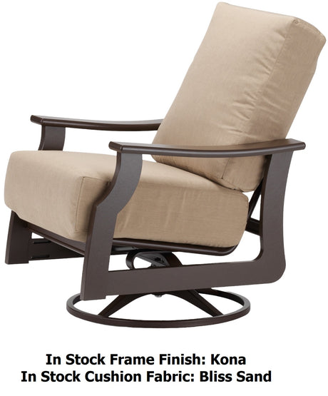 This image shows the swivel rocker chair on a white background. The image also reads "In Stock Frame Finish: Kona. In Stock Cushion Fabric: Bliss Sand."