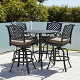 This is a lifestyle image showing this bar height patio furniture set on a stone patio on a sunny day.