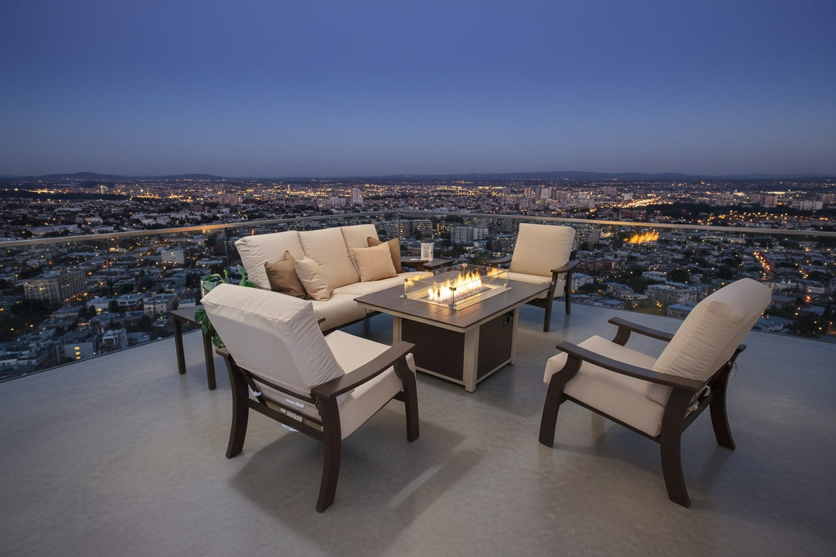 This is a lifestyle image showing this patio furniture set on a terrace overlooking a city at nighttime.