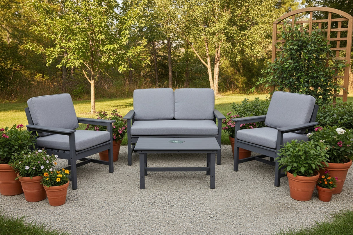 This is a lifestyle image showing this patio set on a gravel patio in a grassy midwestern backyard. The patio features potted plants and a trellis decorated with ivy.