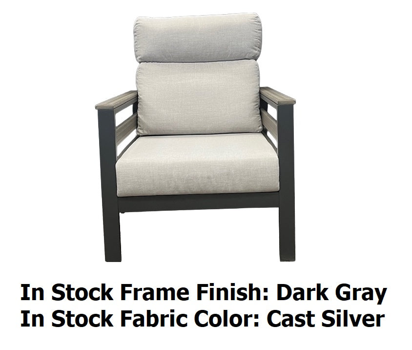 This image shows what the club chair looks like on a white background. The image also reads "In Stock Frame Finish: Dark Gray. In Stock Fabric Color: Cast Silver."