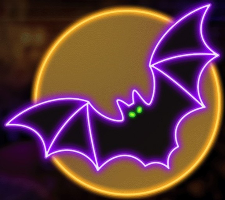 This image shows what this Halloween decoration looks like. It's designed to look like a purple bat with green eyes flying in front of a yellow moon.