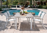 This is a lifestyle image showing this patio dining set on a stone patio next to an in-ground pool.