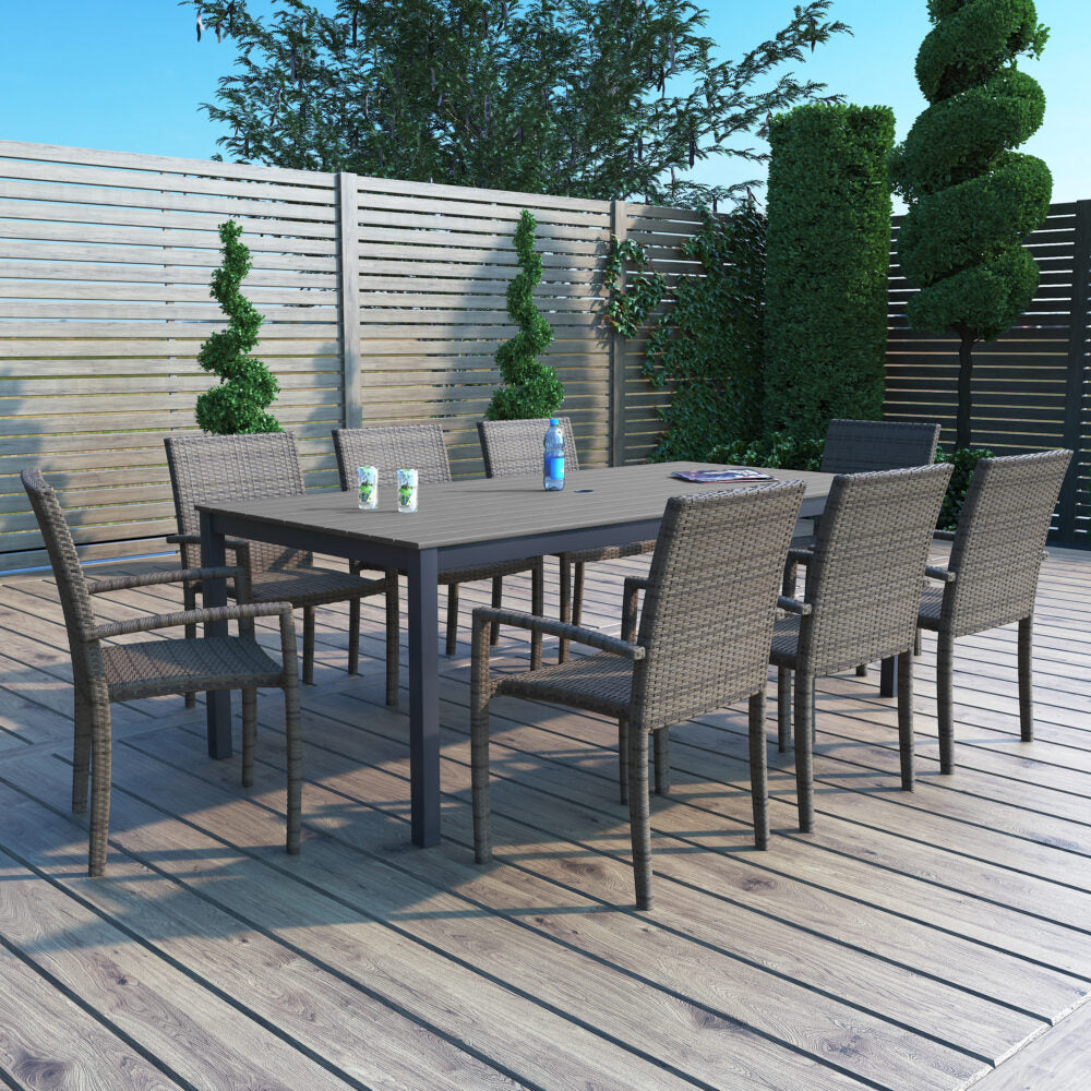 This is a lifestyle image showing this patio dining set on a wooden deck.