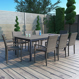 This is a lifestyle image showing this patio dining set on a wooden deck.
