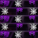 This is a lifestyle image showing this LED Halloween garland. The garland is made up of alternating Halloween motifs: purple spider with green eyes and then white spiderweb.
