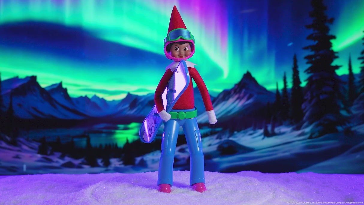 This video showcases a Scout Elf wearing the helmet, goggles and blue magic standing pants. He's holding the snowboard and the aurora borealis is in the background.