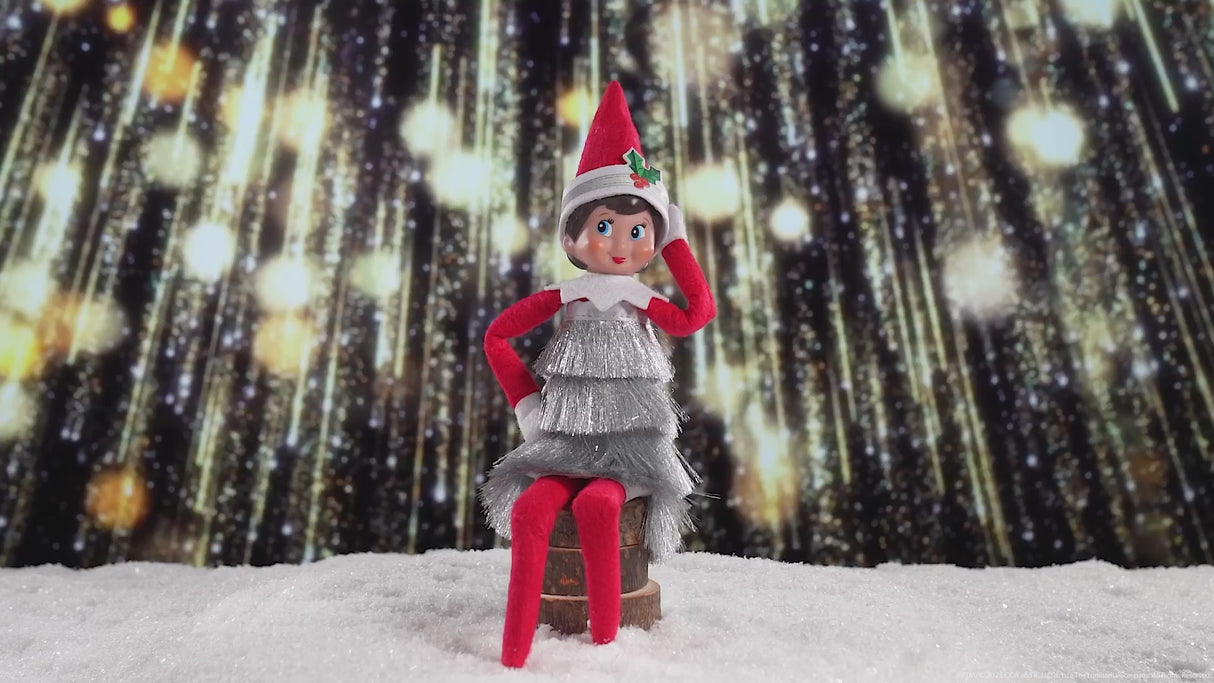 This video showcases the Elf on the Shelf tinsel dress with fireworks in the background.
