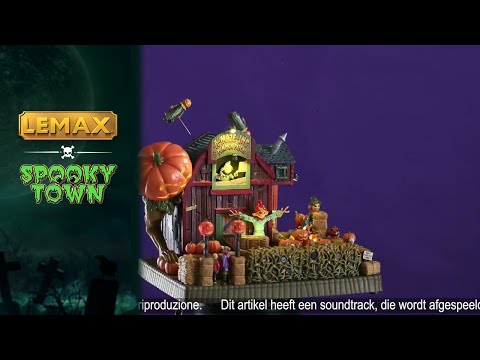 Resin lighted building for a Lemax display. Designed to look like a red barn with a pumpkin patch in front of it. There are scarecrows and jack-o-lanterns. There are weird pumpkin monsters flying above the barn. There are red glowing eyes inside the bales of hay.