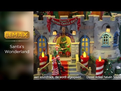 Resin lighted building for a Lemax display. Designed to look like a stone castle decorated for a Christmas gala with Santa. There are people dancing on the balcony and decorative nutcrackers. There are decorated Christmas trees, a snowman and red/white striped candle lights outside.