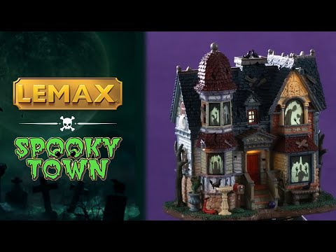 Resin lighted building for a Lemax display. Designed to look like a run down, Victorian-era style mansion. There are ghost shadows in every window and crows all over.