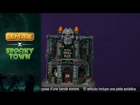 Porcelain lighted building for a Lemax display. Designed to look like a brick building with boarded up windows and skull accents. There are monsters visible inside the bar.