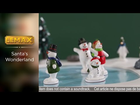 Animated resin table accent for a Lemax display. Designed to look like a frozen pond surrounded by snow and a few rocks. There are five snow people skating on the ice, all wearing winter clothes. There are three polar bears and two penguins watching. The animals are all wearing either a winter hat or a scarf.